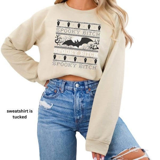 Retro Faux Cross Stitch 'Spooky Bitch' Design - Women's Sand Color Sweatshirt | Vintage Dot Matrix Vibe with a Playful Edge | Perfect Blend Retro Flair & Halloween Spirit | Cozy and Stylish Statement Piece for Spooky Season | Unique, Eye-Catching Design